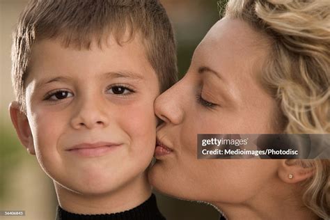 A Mother Holding and Kissing her Son